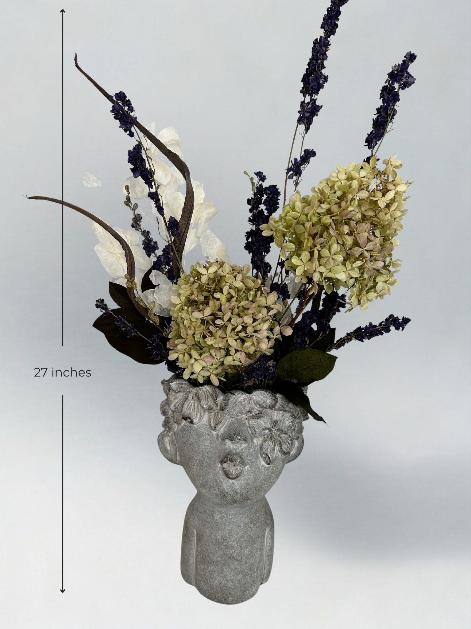 Decorative concrete vase with everlasting floral arrangement on a gray background