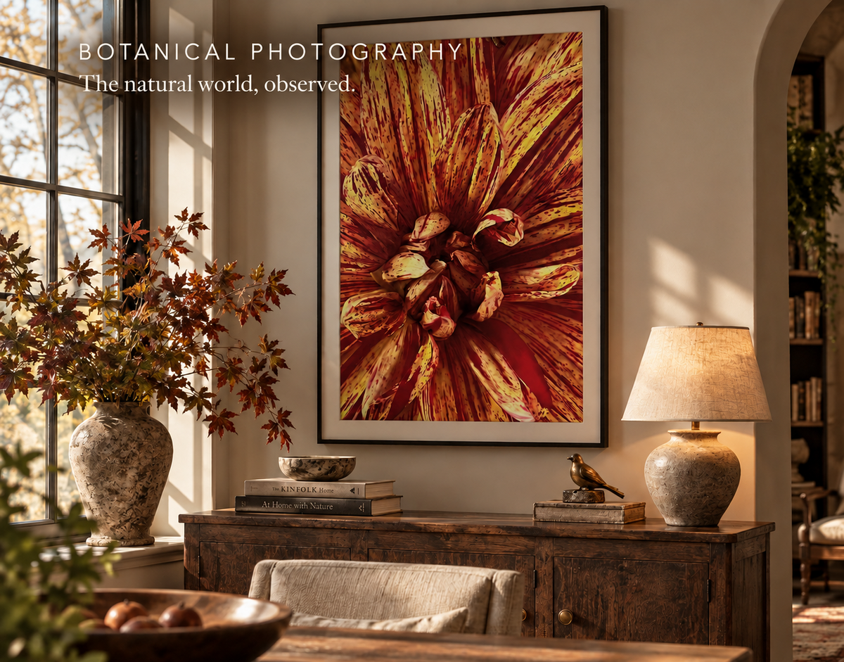 A home office with a beautiful piece of floral photography framed above a wooden console.