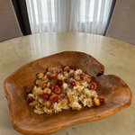 Beautiful hand carved Forest Legacy Bowl made from a fir stump left over from logging industry, filled with dried helichrysum flowers sitting on marble table.
