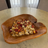 Beautiful hand carved Forest Legacy Bowl made from a fir stump left over from logging industry, filled with dried helichrysum flowers sitting on marble table.