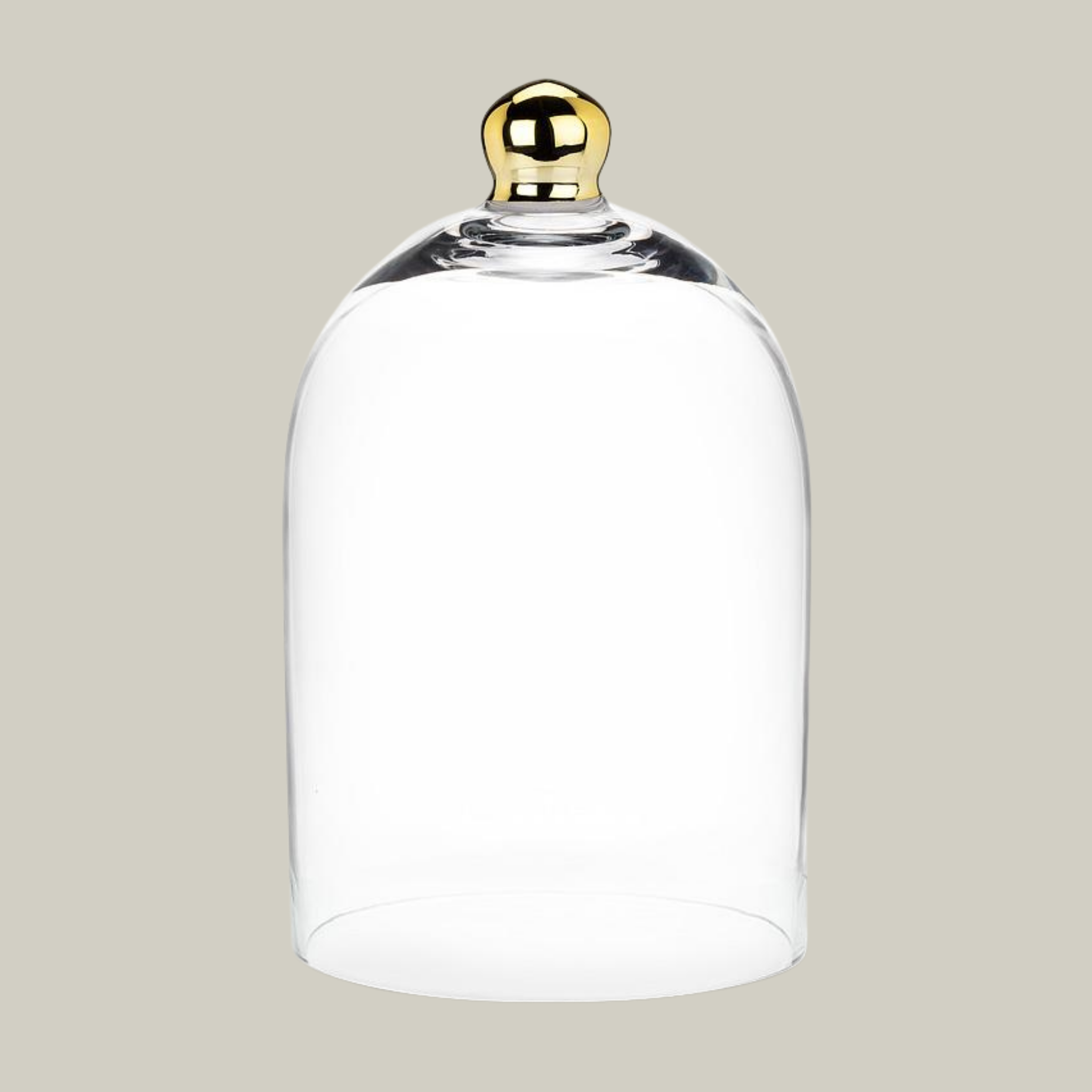 Clear glass cloche with a gold handle on a beige background