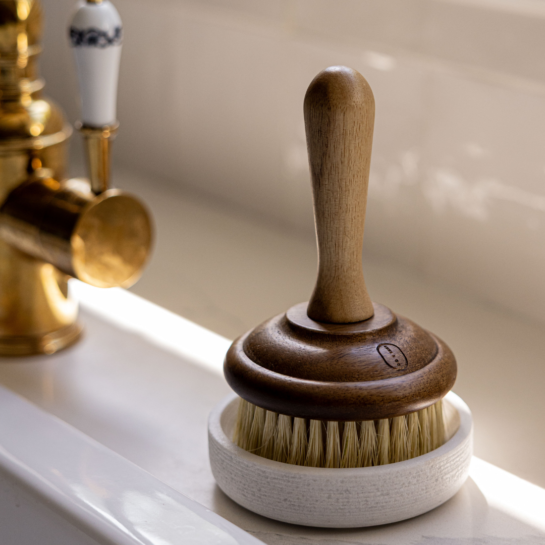 Wooden brush with a white handle on a sink