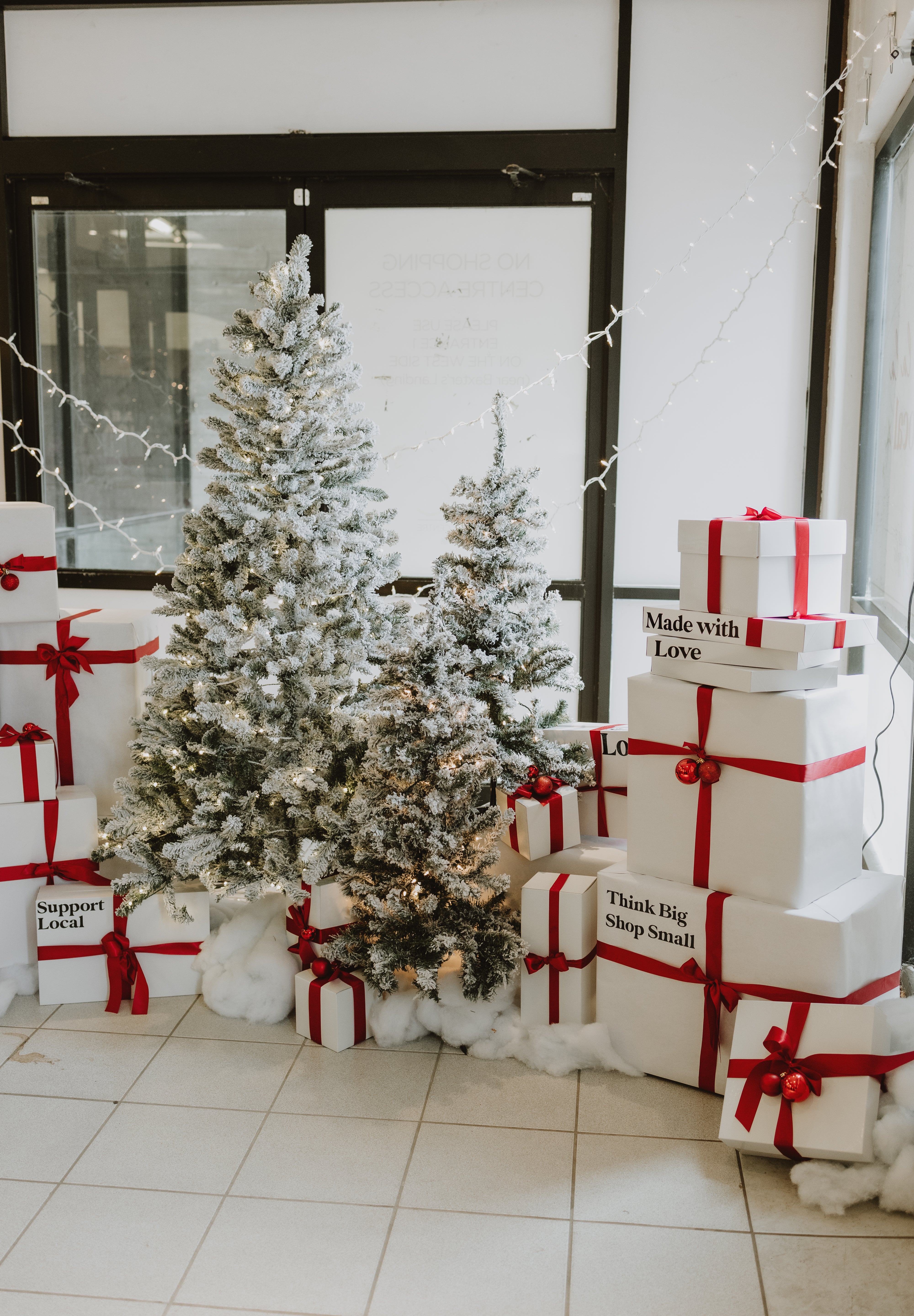 Decorative Christmas scene with trees and wrapped gifts at the 10th Annual Holiday Market in the OshawaCentre.