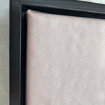 Close-up of a black picture frame corner on a light gray background
