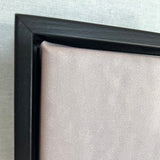 Close-up of a black picture frame corner on a light gray background