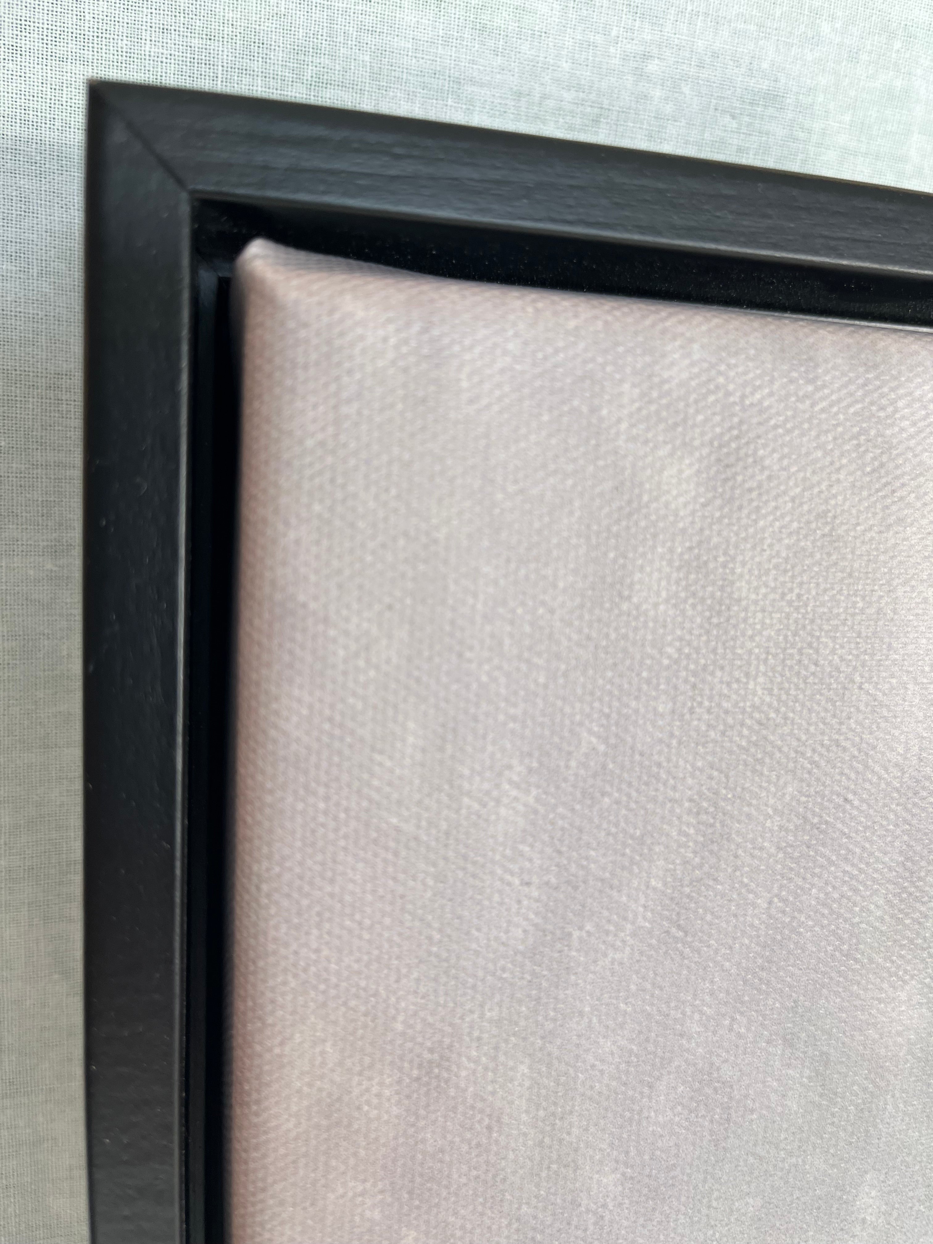 Close-up of a black picture frame corner on a light gray background
