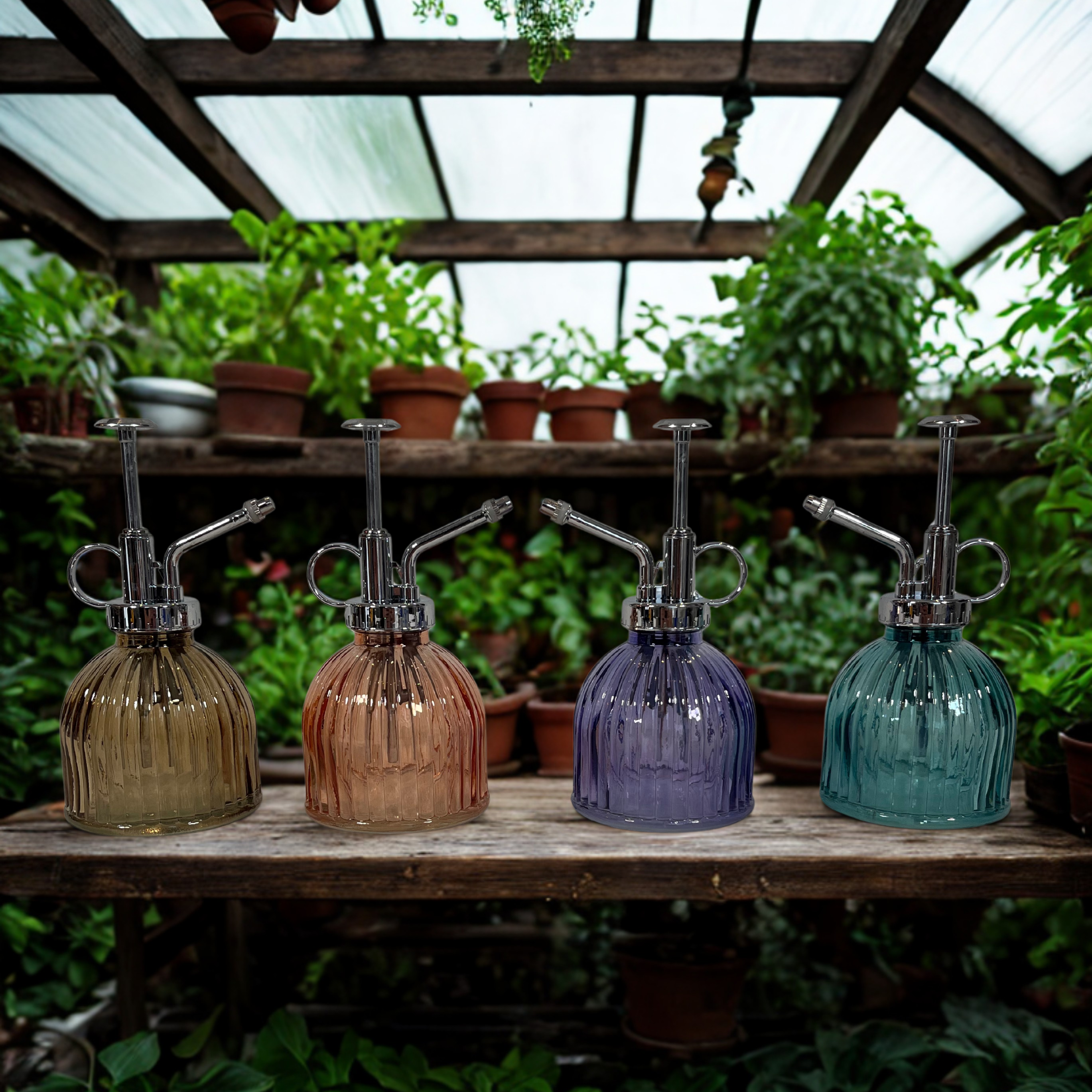 Four glass plant misters on a wooden shelf with plants in the background