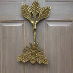 Brass bee-shaped hook on a wood door