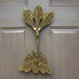 Brass bee-shaped hook on a wood door
