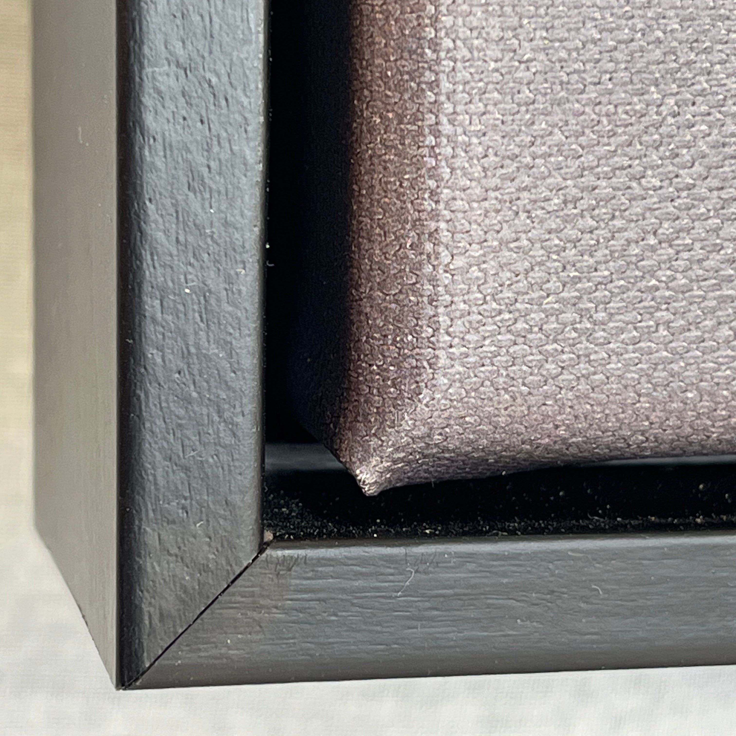 Close-up of a black picture frame corner on a white background