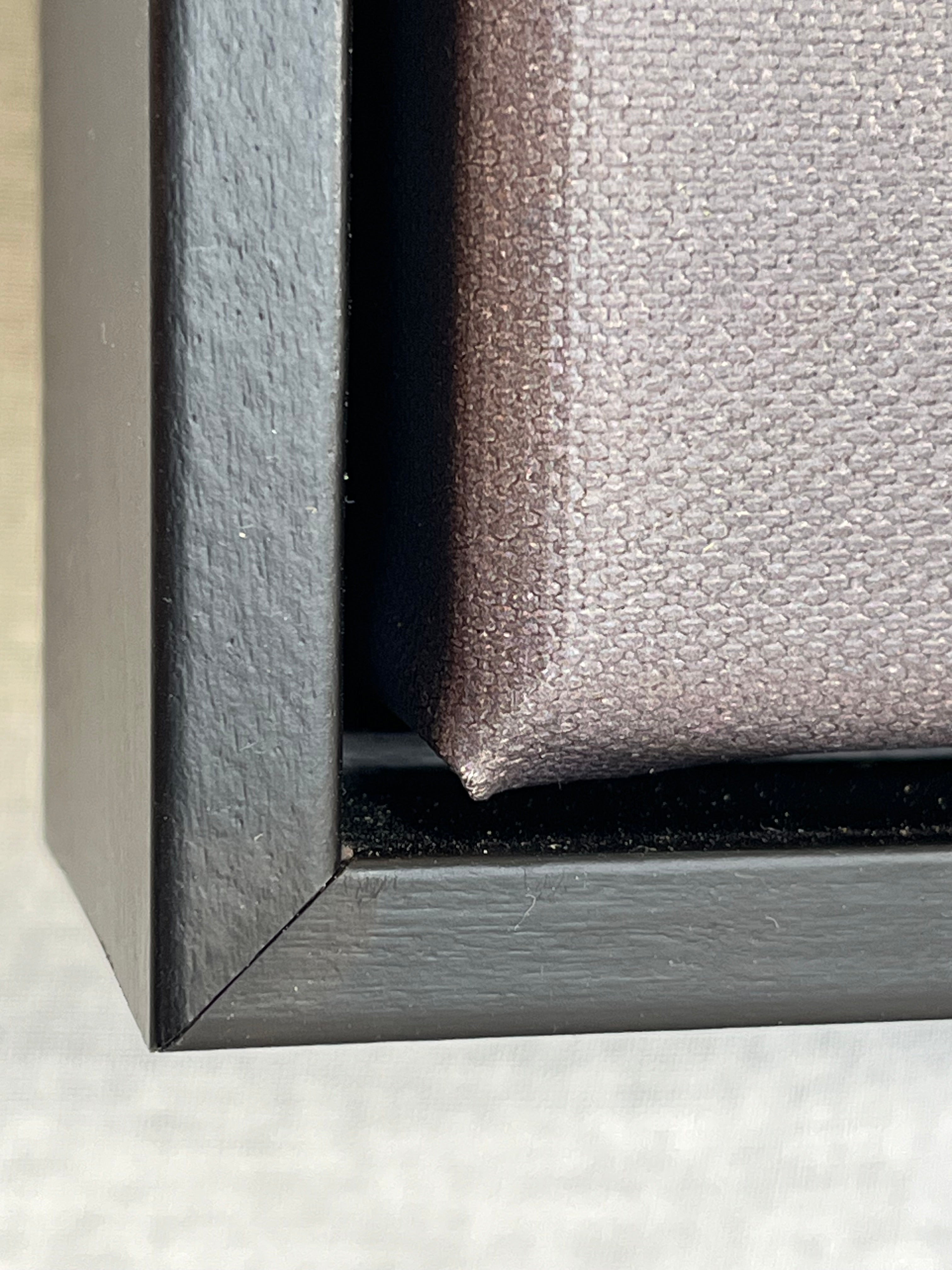 Close-up of a black picture frame corner on a white background