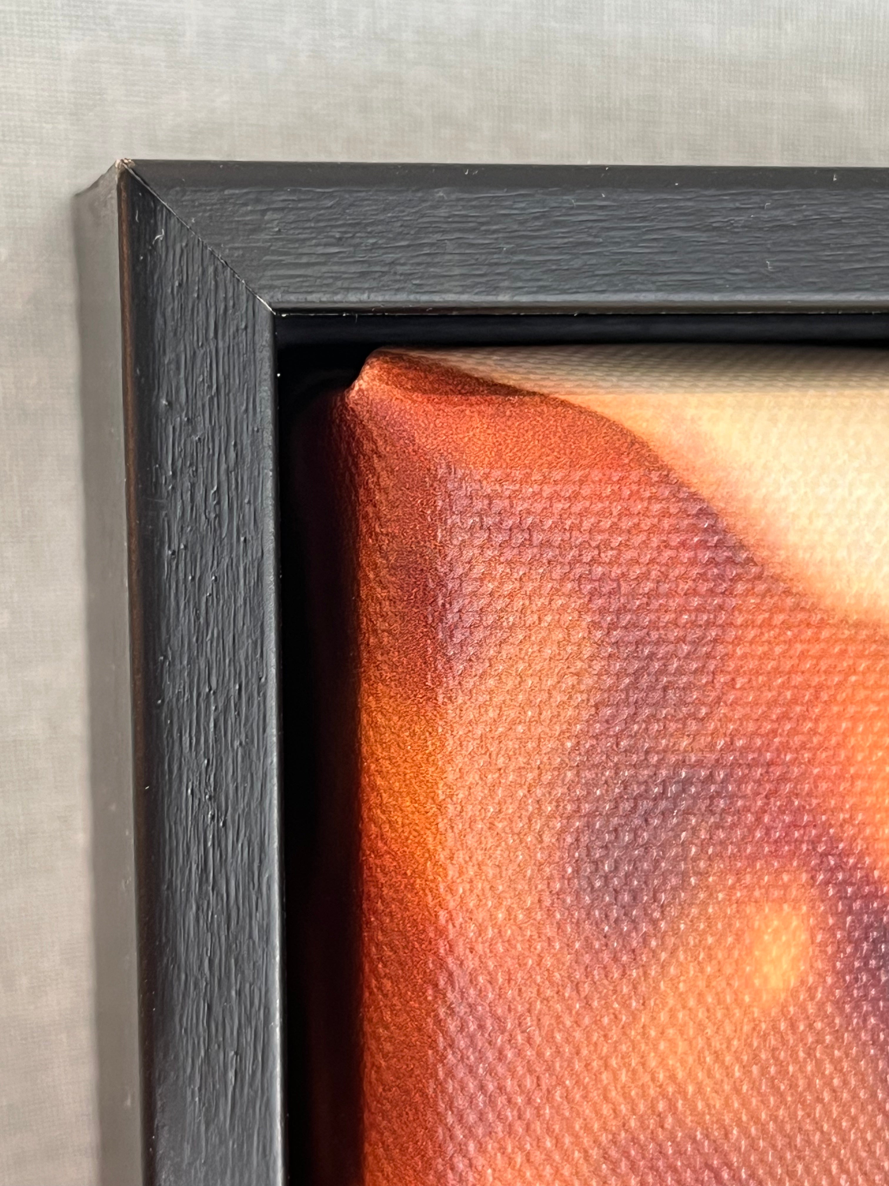 Close-up of the corner details of a photograph with a textured surface and black frame.