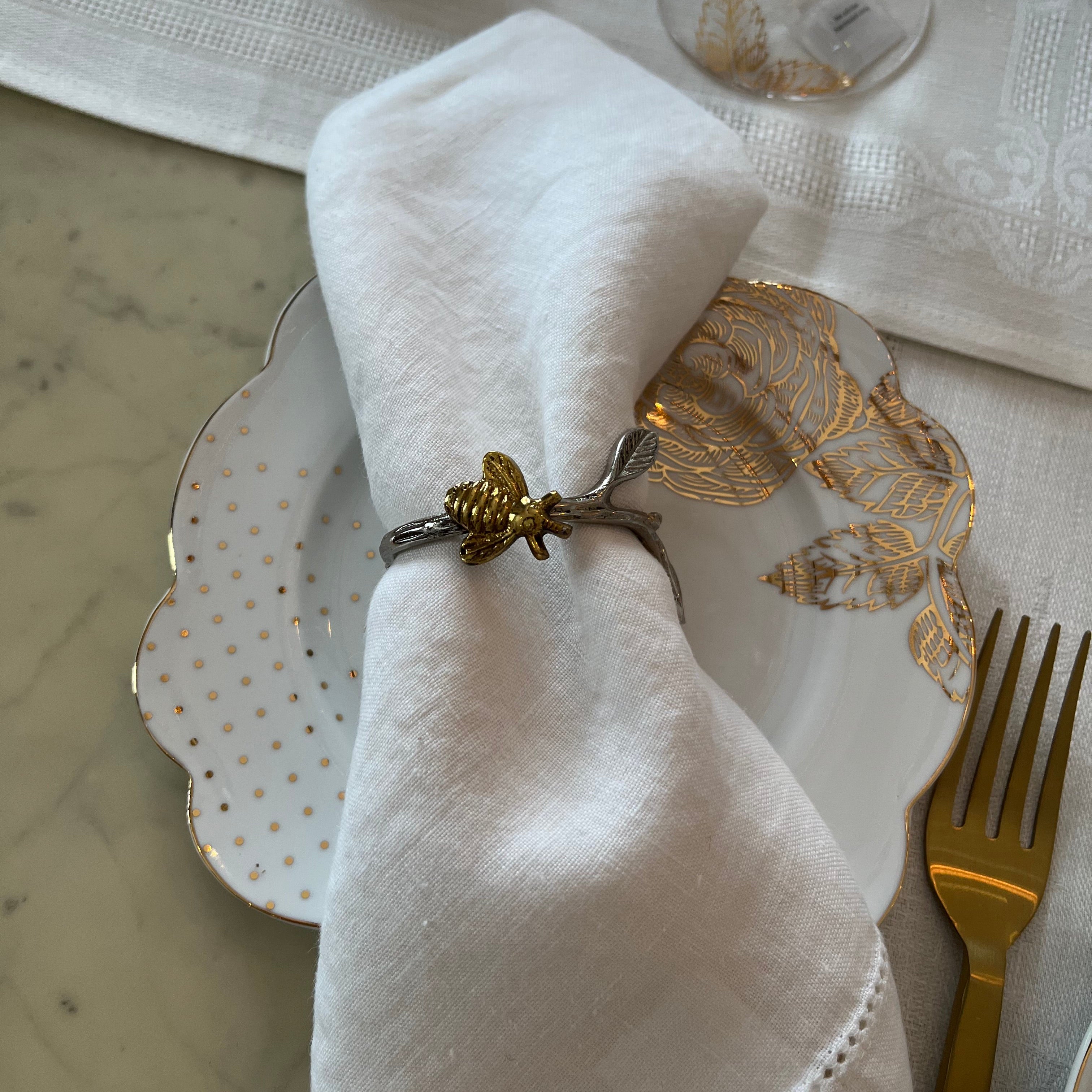 Elegant table setting featuring Pip Studio Royal White cake plate with a linen napkin and our Golden Hive napkin ring. 