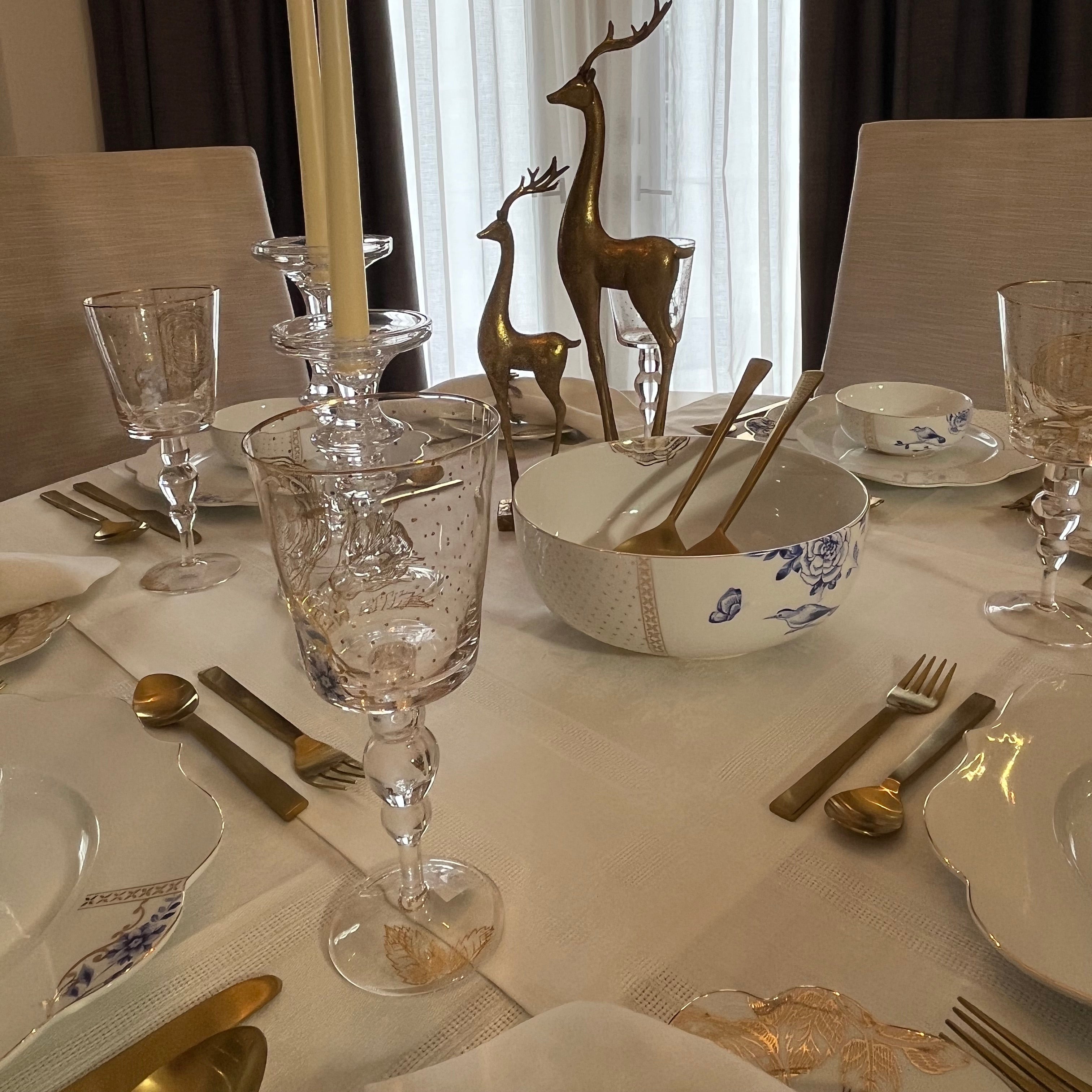 Dining table set with Pip Studio Royal White dinnerware, Royal Flower glasses, and our Gilded flatware in a formal setting.