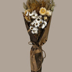 This striking, hand-tied bouquet is a harmonious blend of dried botanicals in deep red, soft pink, and natural oats, carefully curated and wrapped in a polished rendition of classic vintage newspaper. 