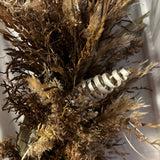 A close-up of this impressive 28 inch wreath is made with the elegance of spider wood and the airy lightness of Star Grass. It is a rich tapestry of grains, including the unique forms of Sorghum, dried Rice Ears, and graceful Arena Wild Oats. Sculptural bleached cane cones and the whimsical twists of bleached curly ting ting add the final, enchanting touches.