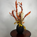 A magnificent 30" dried floral arrangement with autumn botanicals like helichrysum, dahlias, & oak leaves in a matte brown urn.