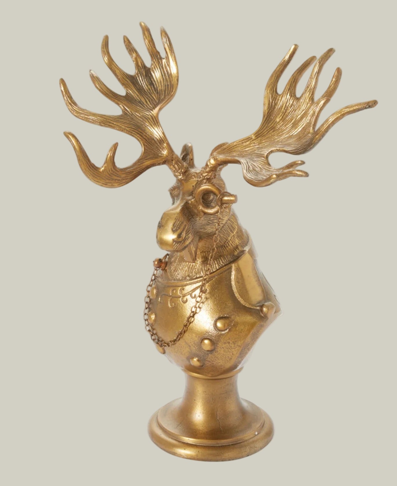 Eugene the Moose Bronze Bust in uniform sporting a monocle with his large antlers and sombre expression. He is a friendly, refined character who brings the charm and whimsical elegance of a storybook into your home.