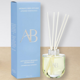 Aromatherapy diffuser with packaging on a beige surface