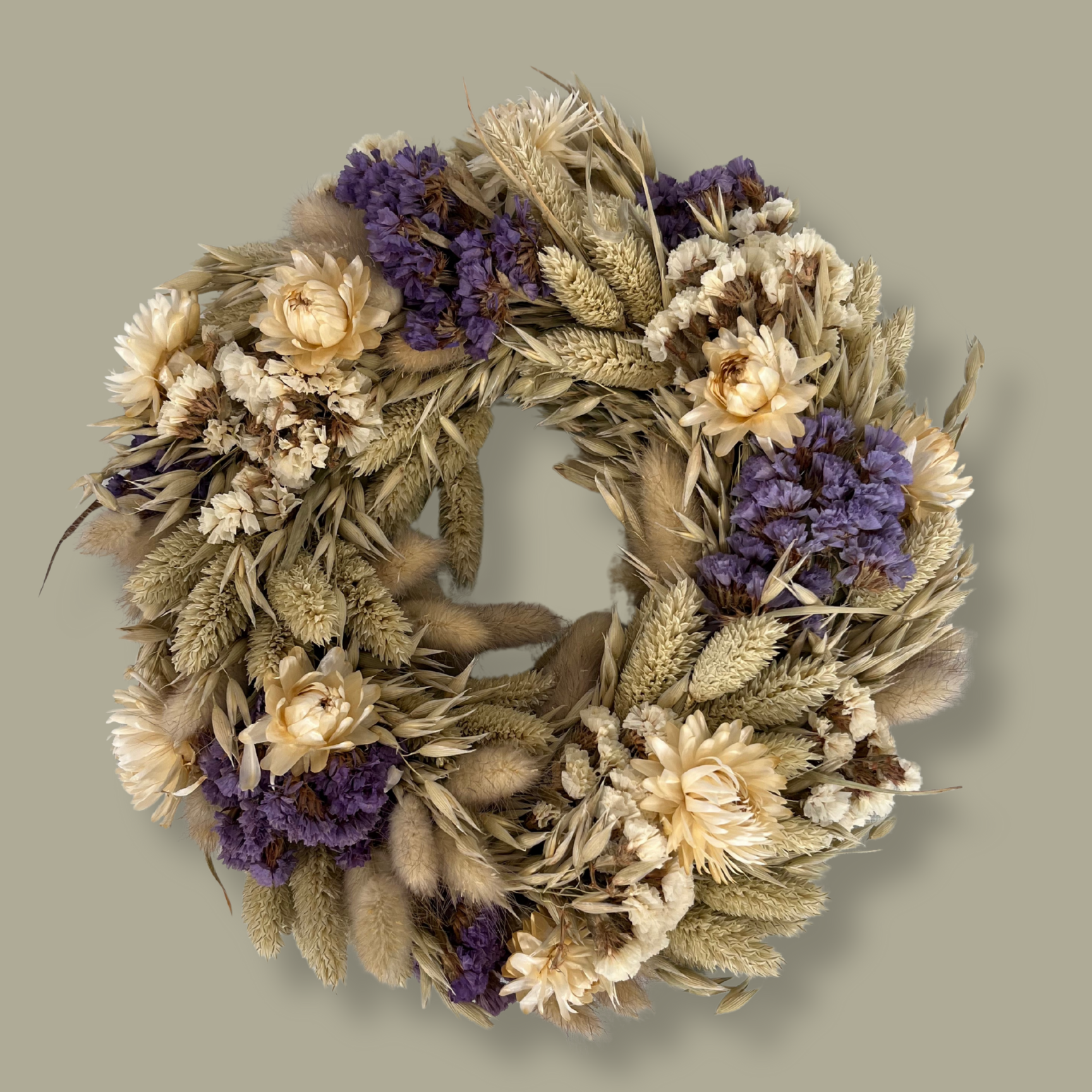 10-inch wreath made with lush purple Statice, creamy natural strawflowers, feathery bunny tails, delicate Larurus ovatus, and graceful natural oat grass. 