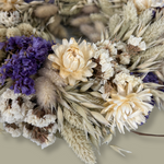 Close-up view of a 10-inch wreath made with lush purple Statice, creamy natural strawflowers, feathery bunny tails, delicate Larurus ovatus, and graceful natural oat grass.  4