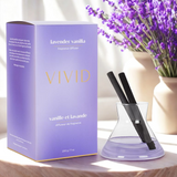 Vivid lavender vanilla fragrance diffuser with packaging and a vase of lavender flowers.