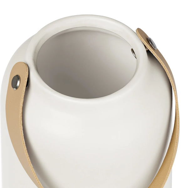 Close-up of the opening of a white ceramic vase with matte finish and faux leather handle 