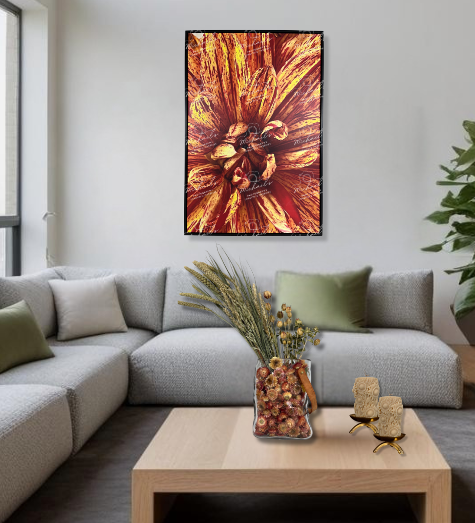 Modern living room with a gray sectional sofa, wooden coffee table with stunning everlasting floral arrangement, sunflower embossed pillar candles, and beautiful botanical art of a close-up shot of a Dahlia