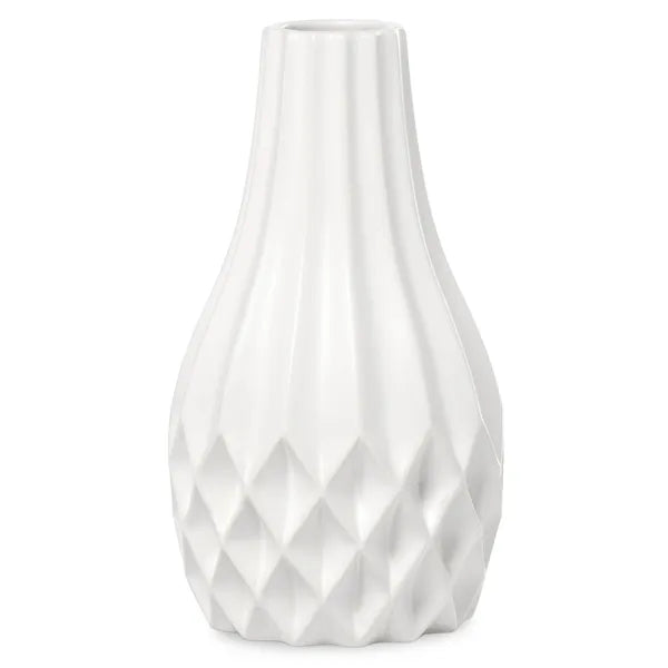 A white ceramic vase with a fluted, ribbed body and a faceted diamond-patterned base, shown against a plain white background.