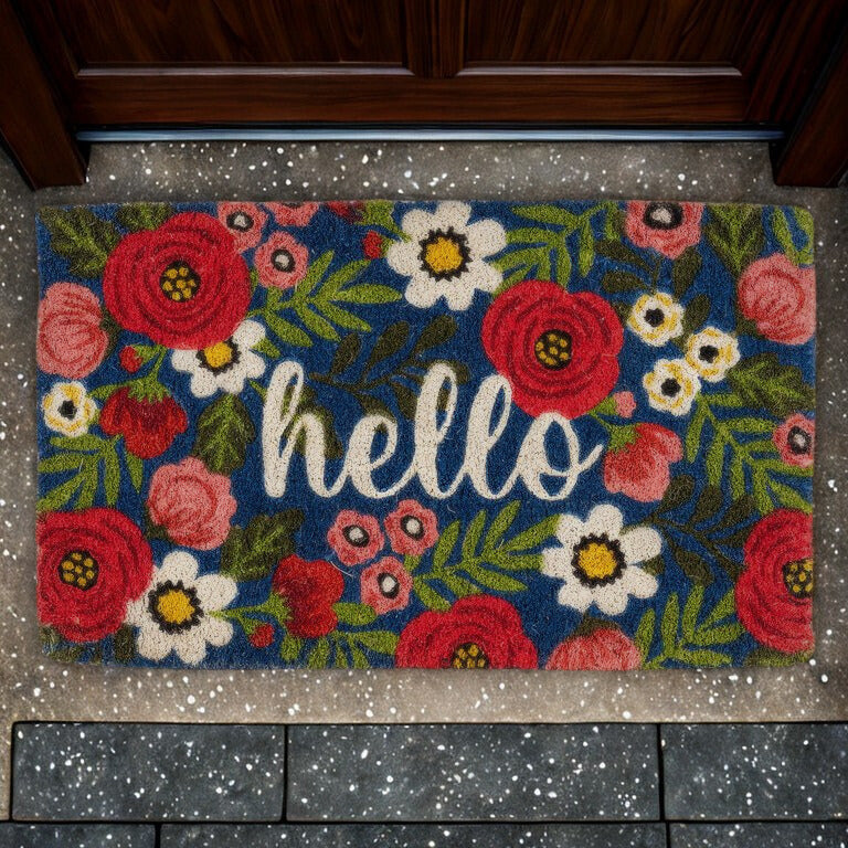 Floral doormat with 'hello' text on a snowy ground