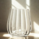 Clear glass vase on a wooden surface with soft lighting