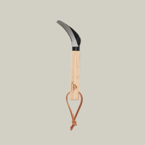 Traditional gardening tool for cutting plant roots with a curved blade and wooden handle on a white background