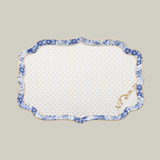 Rectangular porcelain white serving plate with gold and blue floral patterns on a soft green background