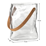 Clear glass vase shaped like a paper bag with faux leather with dimensions 9.5 inches tall, 7.5 inches wide, and 4 inches deep.
