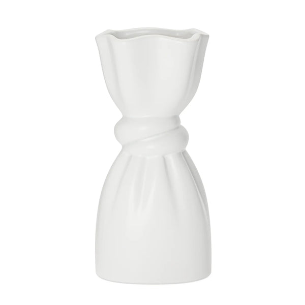White ceramic vase with a delicate cinch midway that creates a graceful twist on a white background.