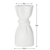 White ceramic vase with a delicate cinch midway that creates a graceful twist with dimensions of 10 inches tall, 4.5 inches in diameter at the base and 4 inches in diameter at the opening.
