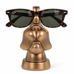 Sunglasses with a tortoiseshell pattern and dark green lenses, displayed on a metallic gold dog head stand against a white background.