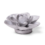 A small ceramic Gardenia sculpture with layered petals and a circular base, shown on a clean white background.