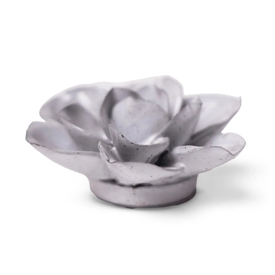 A small ceramic Gardenia sculpture with layered petals and a circular base, shown on a clean white background.