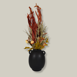 A magnificent 30" dried floral arrangement with autumn botanicals like helichrysum, dahlias, & oak leaves in a matte brown urn.