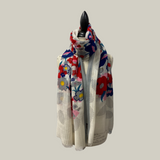 Colorful floral-patterned scarf on a mannequin against a light gray background