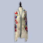 Floral patterned cardigan on a mannequin against a light blue background