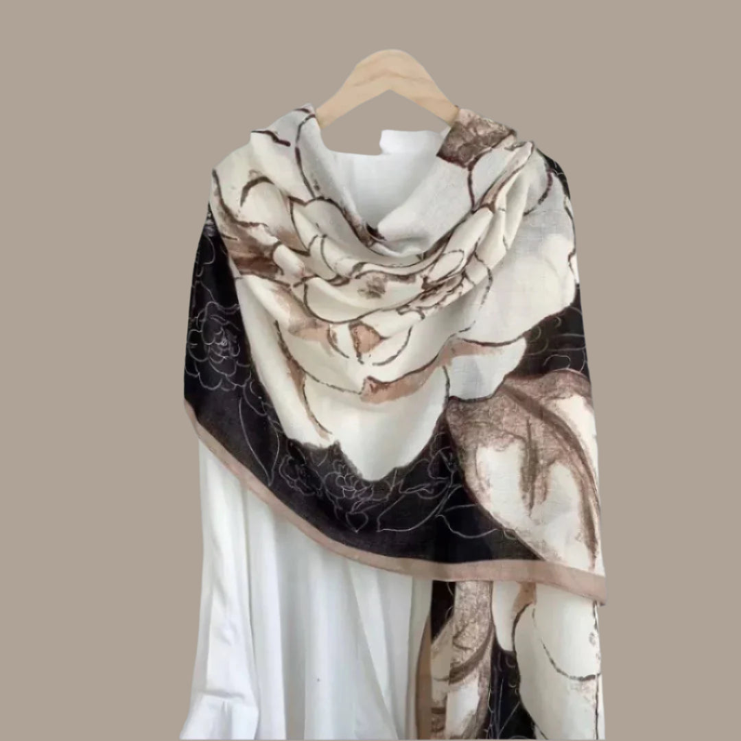 Floral patterned scarf draped over a white linen shirt.