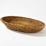 Side view of a large round seagrass tray showing the beautiful weave and finish around the rim. 3