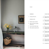Room interior with a table, basket, and vase of flowers, alongside a book with text on a white background.