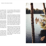 Open book with text on the left and a scenic view of a lake with trees on the right.