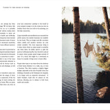 Open book with text on the left and a scenic view of a lake with trees on the right.