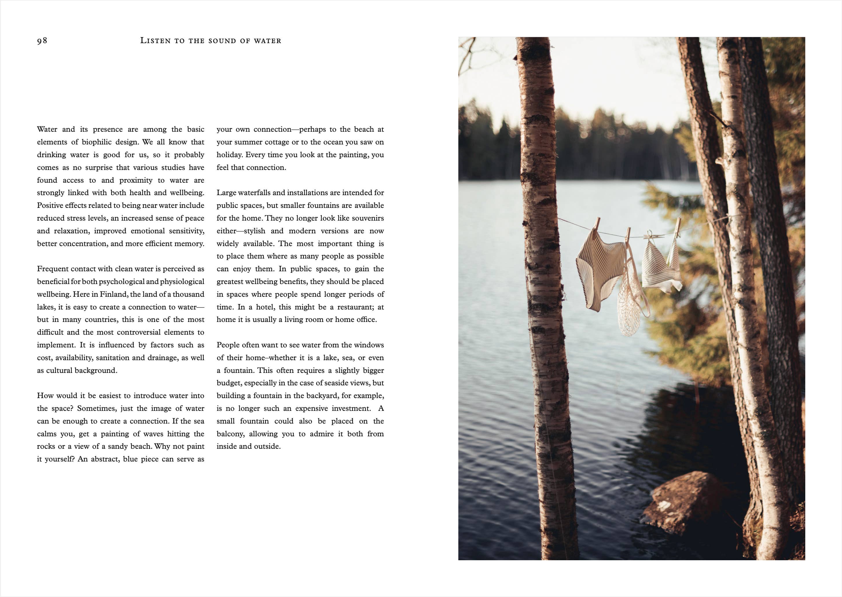 Open book with text on the left and a scenic view of a lake with trees on the right.