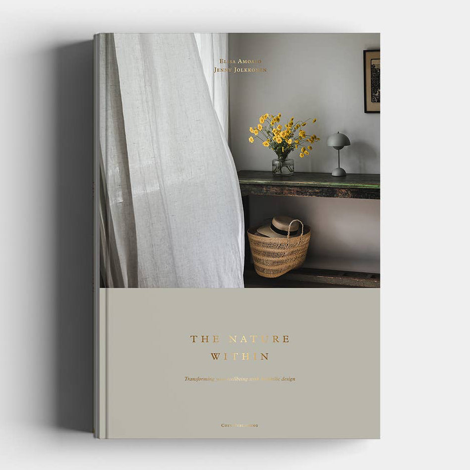 Book titled 'The Nature of Women' with a cover featuring a room interior.