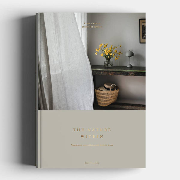 Book titled 'The Nature of Women' with a cover featuring a room interior.